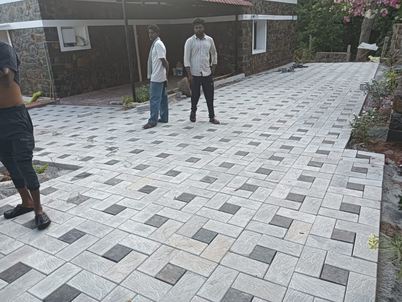 Paved area with grey, white and black rectangle tiles